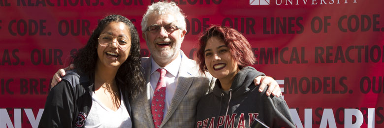 students posing with President Struppa