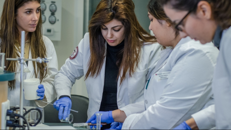 Graduate students work in a lab environment.