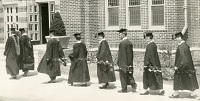 college graduates holding vines