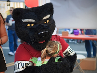 team mascot hugging child