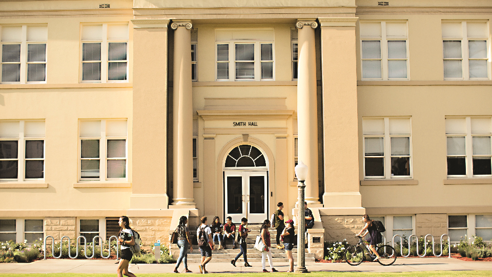 Students walking past building on Chapman University campus