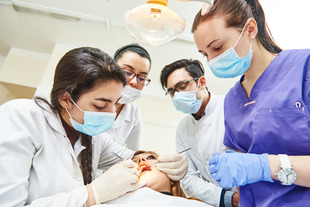 Dental students working on a patient