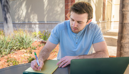 Student writing on a notepad