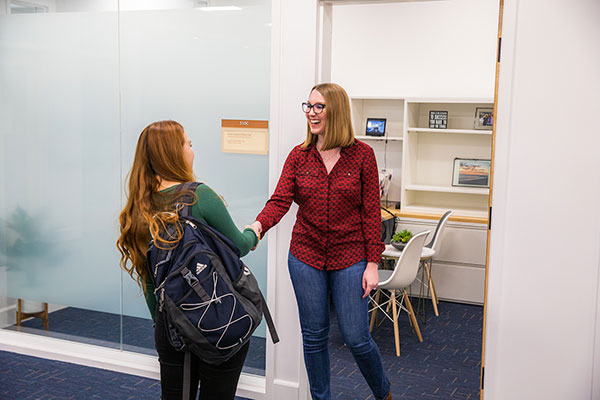 Advisor meets with student in office