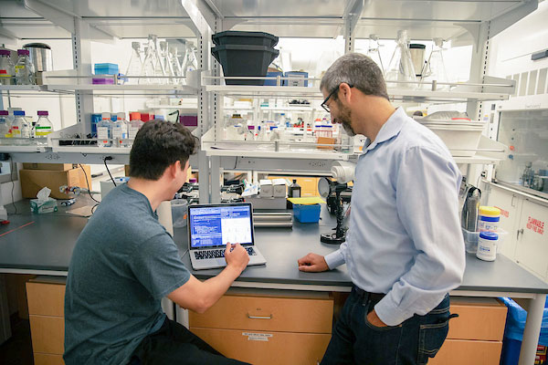 Student and faculty member in lab setting