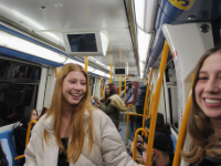 Girls smile while riding public transportation