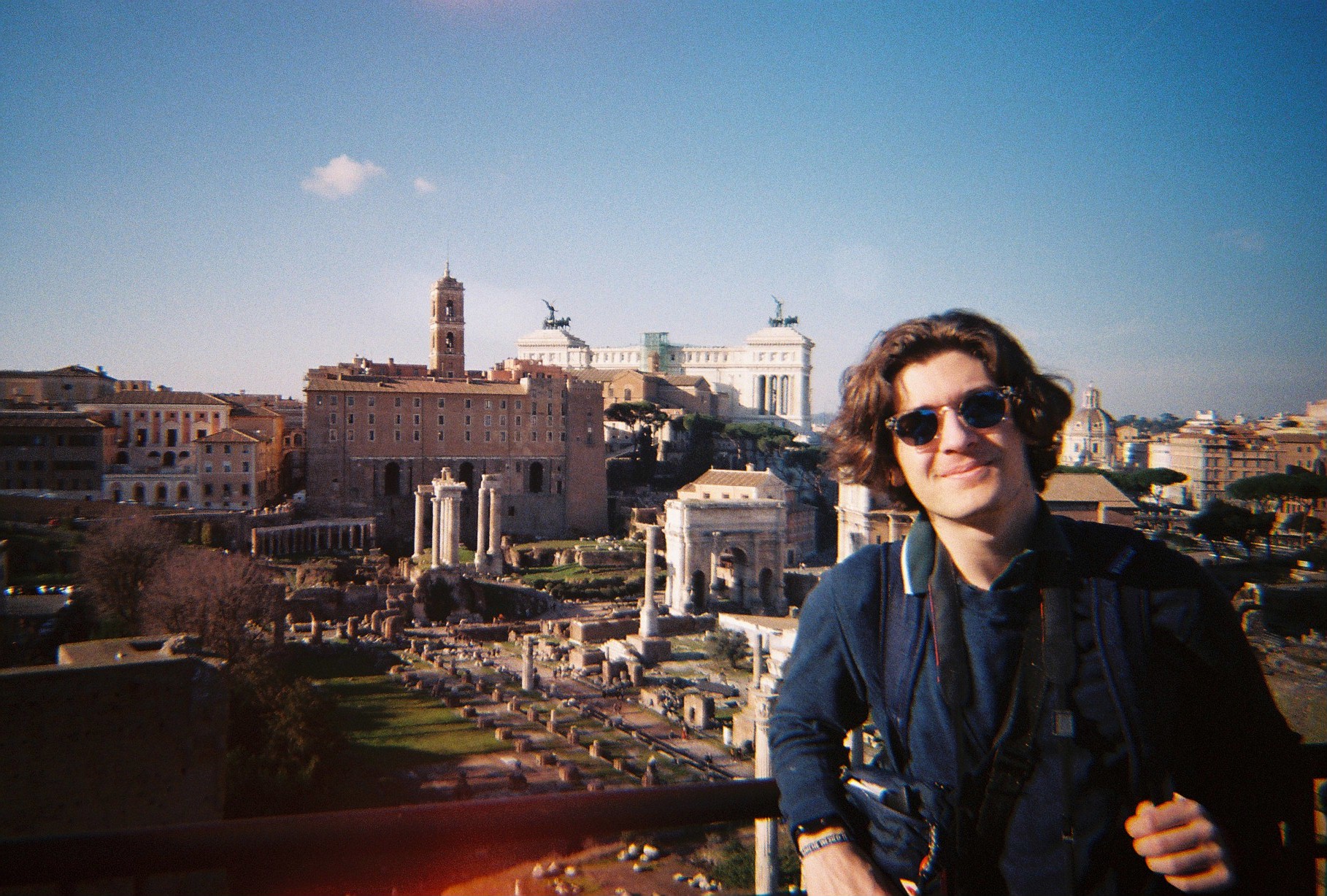 Student poses in front of city scape while studying abroad