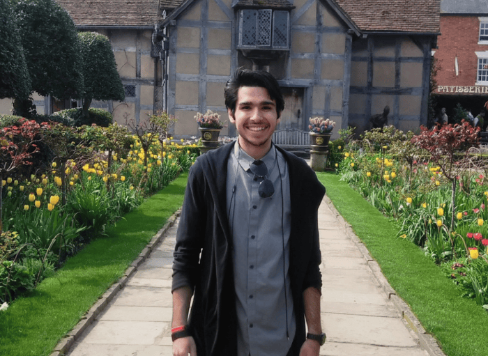 Student in front of a village home in England.