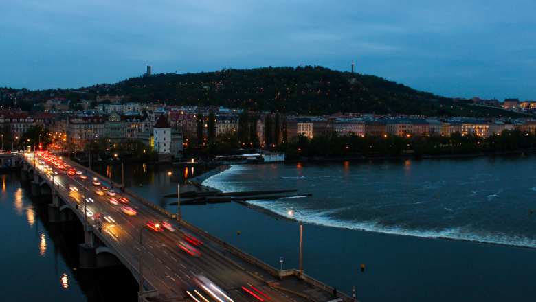 Bridge and cityscape near water at night