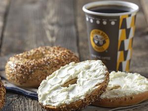 Bagels with cream cheese and a cup of coffee.