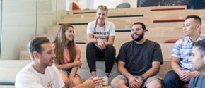 Students having a discussion while sitting on a staircase