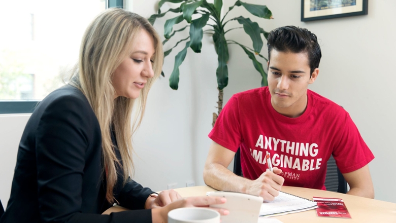 A financial aid counselor meeting with a Chapman University student