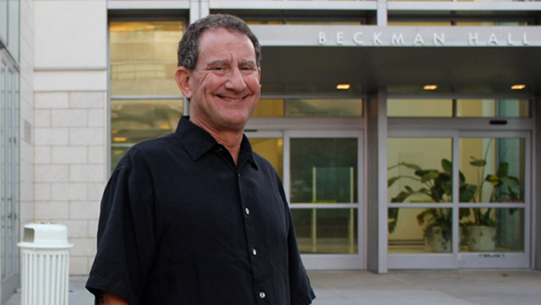 Faculty member outside the Argyros College at Chapman University.