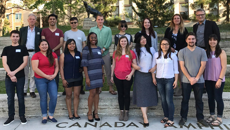 New students at the Argyros College of Business and Economics posing in Attallah Piazza at Chapman University