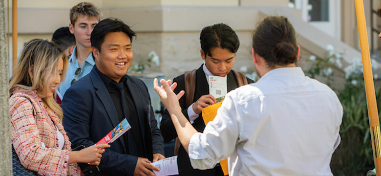 alumni handing each other business cards