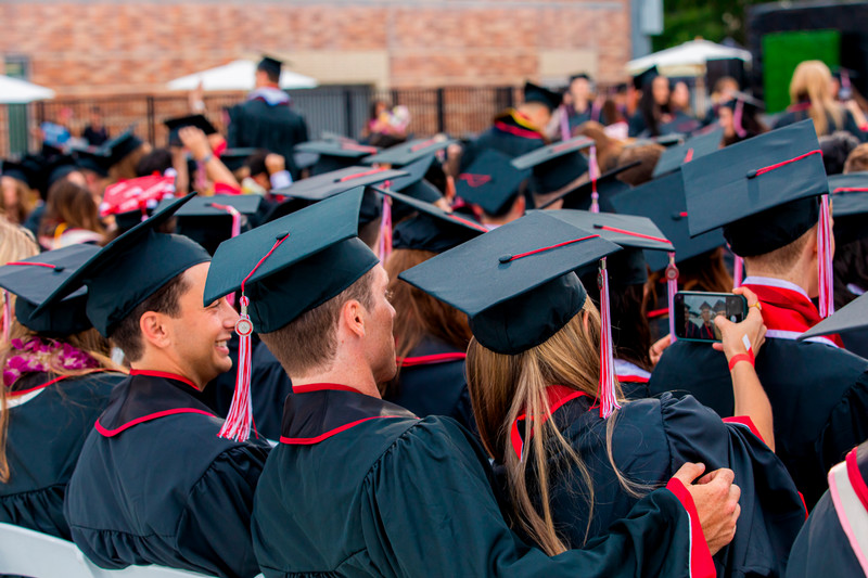 Graduating students take selfie at ceremony