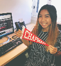 Student posing with Chapman pennant