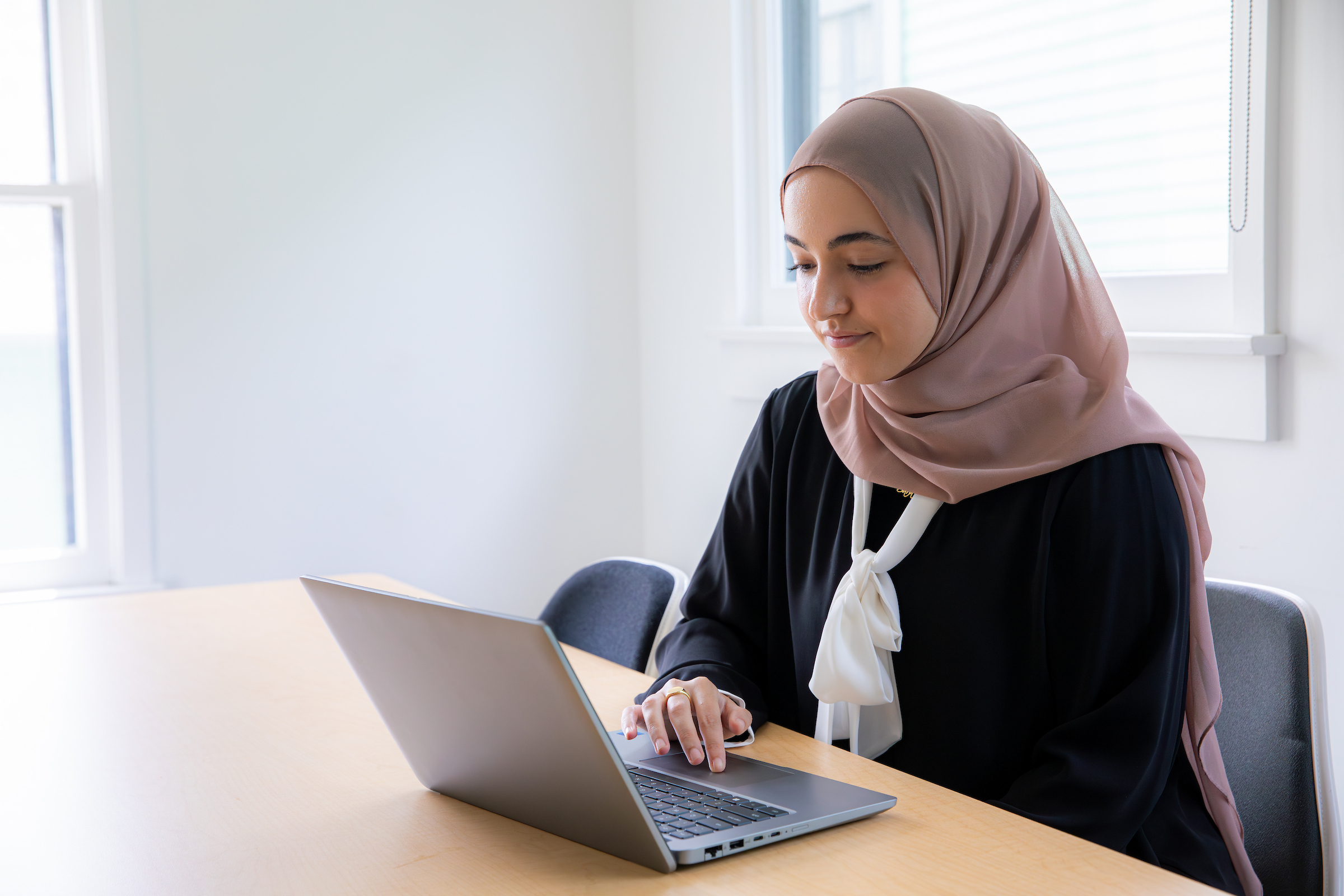 Woman works on laptop at desk