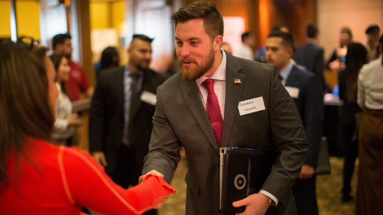 candidate shaking hands with employer at career fair