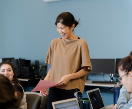 Instructor teaching smiling at students