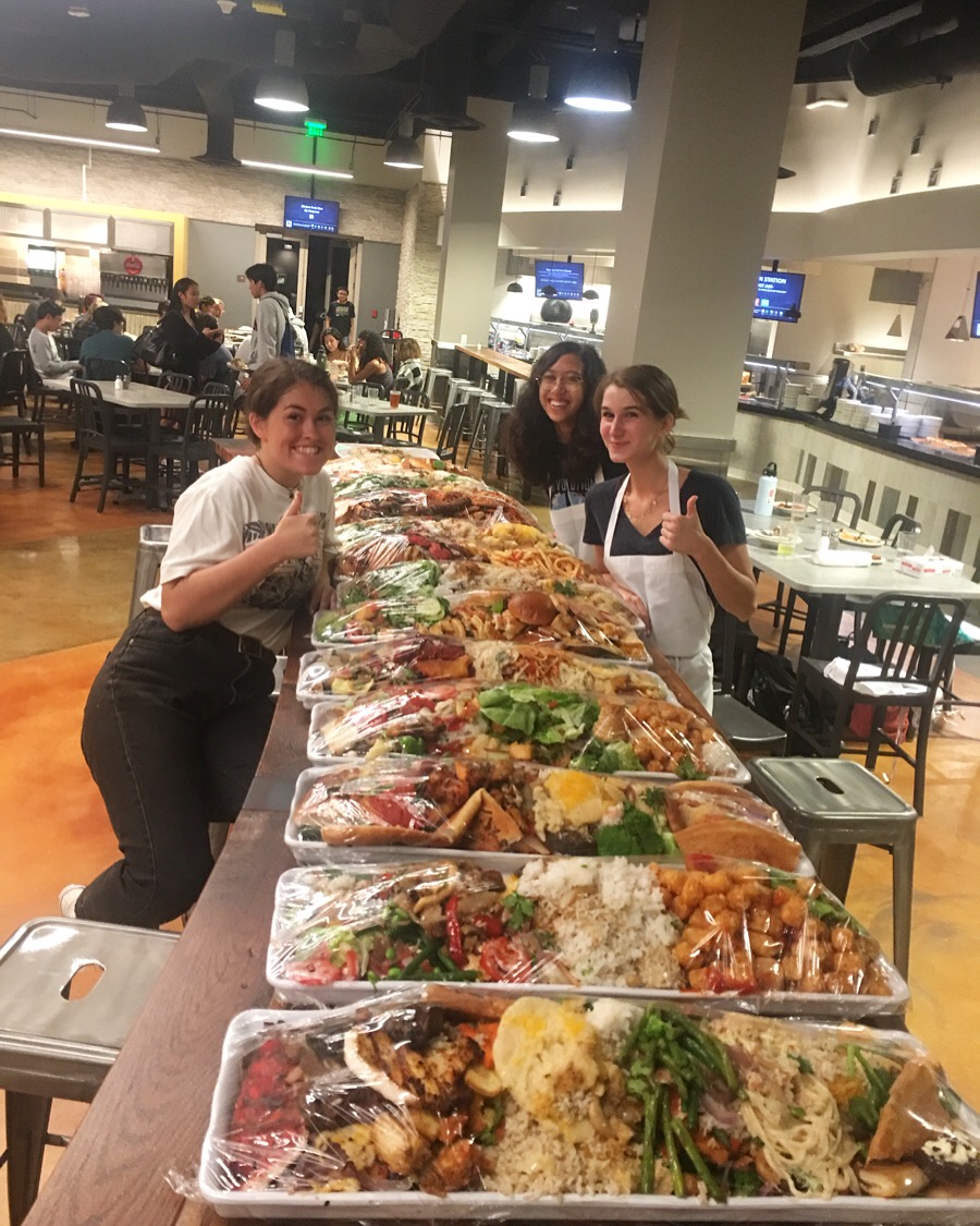 students near trays of uneaten food