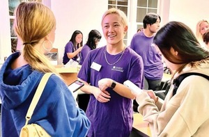 Students speak with a Trailblazers student at an information session.