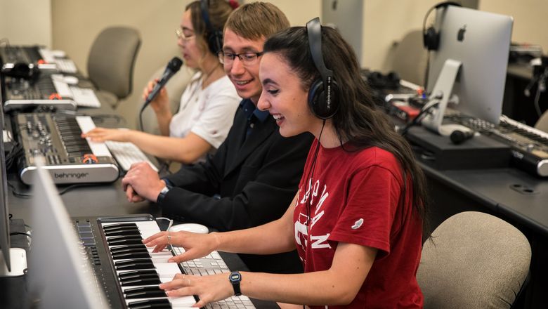 Students compose music in a classroom