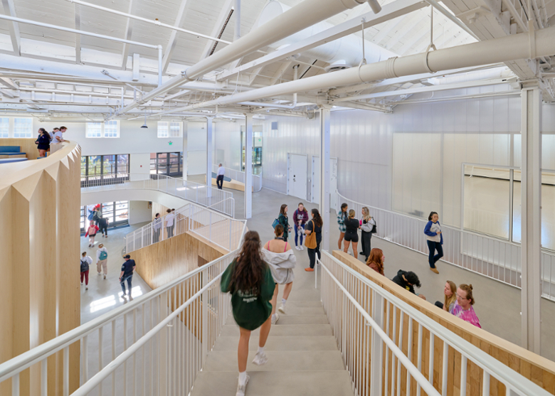 Students walk from the loft down stairs to level two and one.