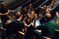 students listening to instructor in a theatre