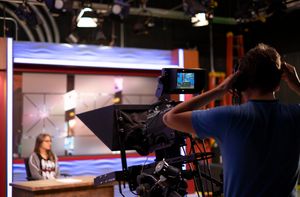 A student giving a news report in a studio