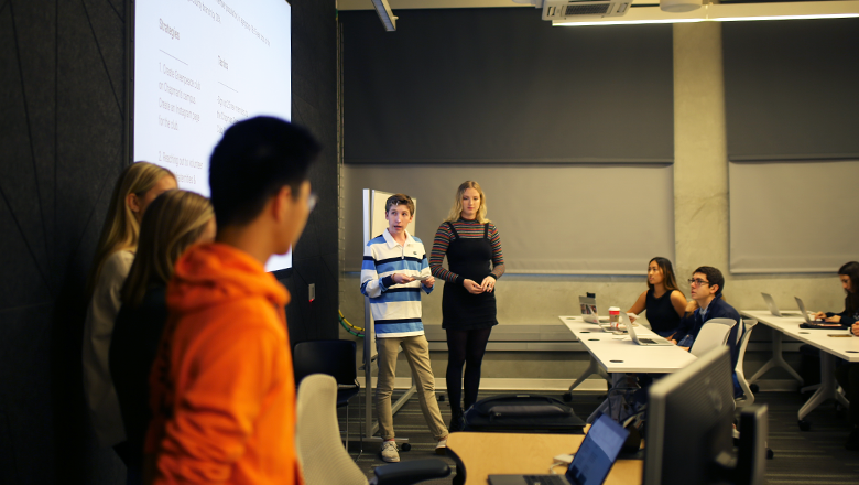 Students giving a presentation in class.