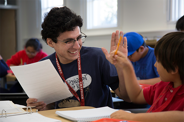 High fiving a student