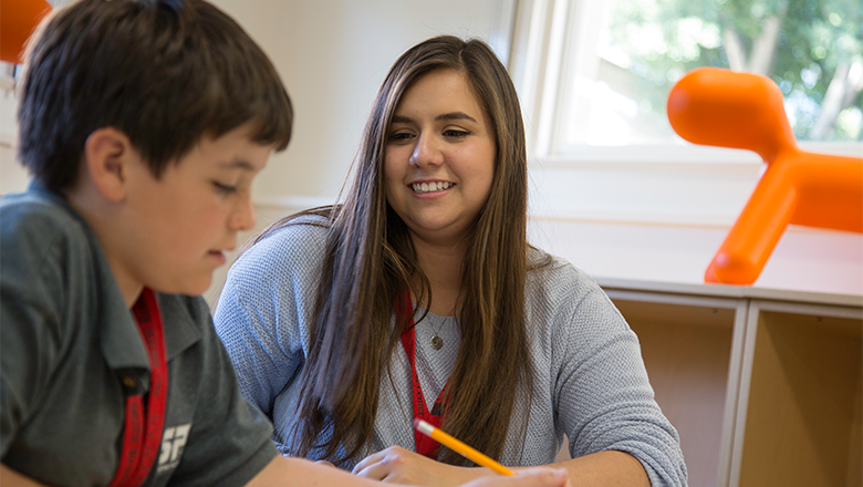 teacher working with boy