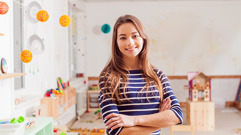 Teacher standing in classroom.