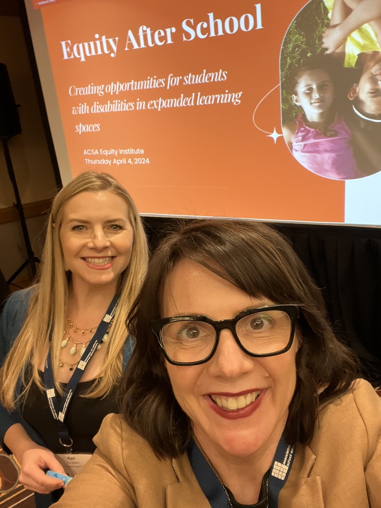 women standing in front of their presentation 