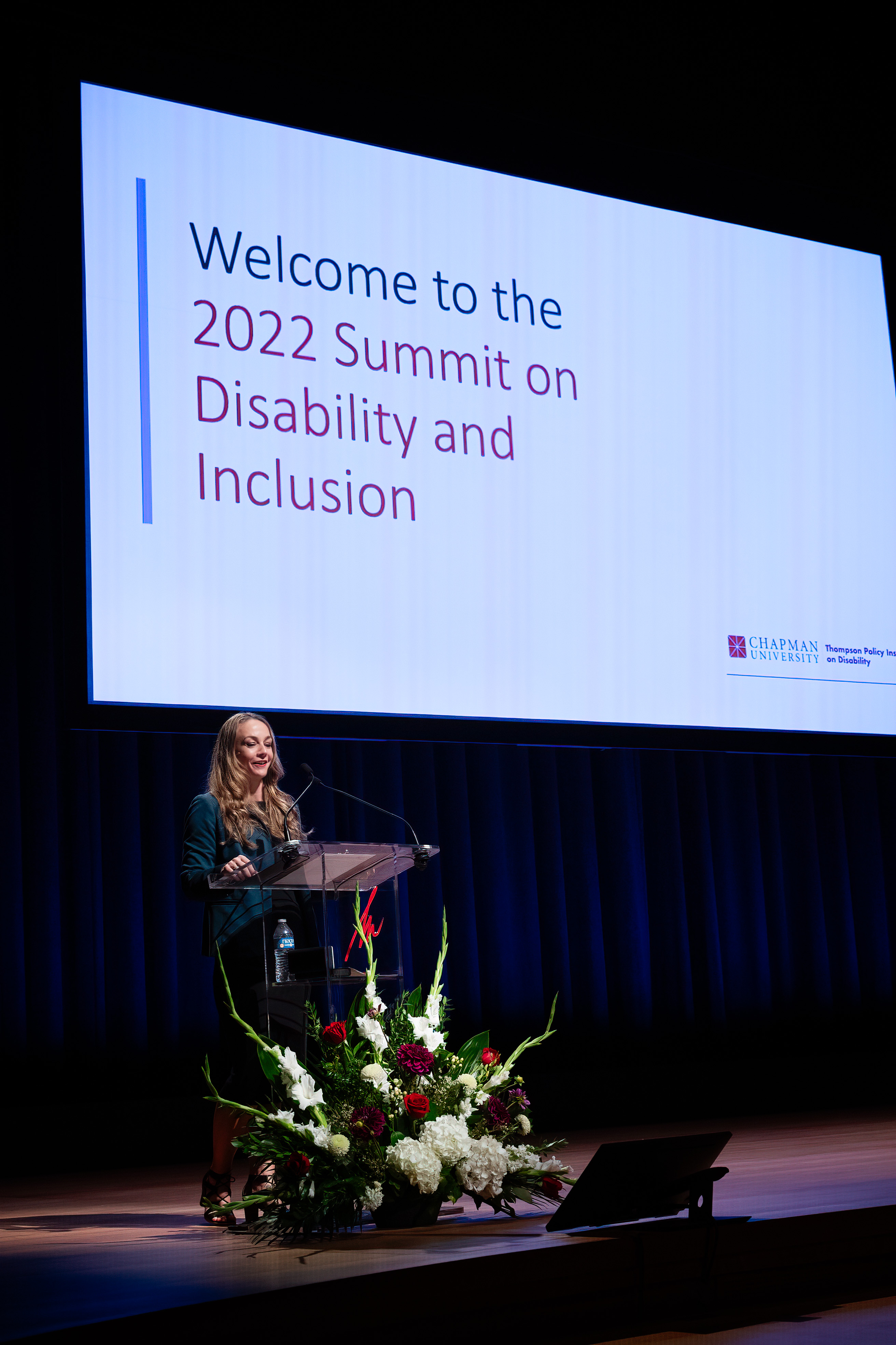 Presenter Dr. Meghan Cosier presenting at a podium.