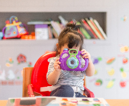 Child looking through toy camera. Photo by Tanaphong Toochinda on Unsplash