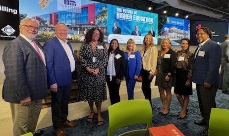 Chapman University Faculty and Staff are standing in a line in front of the stage. Pictured from left to right - President Daniele Struppa, Vice President Joe Sloensky, Misty Levingston, Araceli Martinez, Roxanne Greitz Miller, Meghan Cosier, Audri Sandoval Gomez, Gabriela Castaneda, and Reg Chhen Stewart.