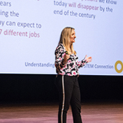 Woman presenting on stage