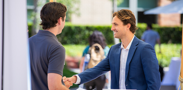 Employer partner engaging a student at career fair