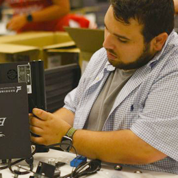 A student assembles an electronic device.