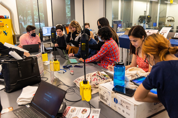 Two students work in an engineering classroom.