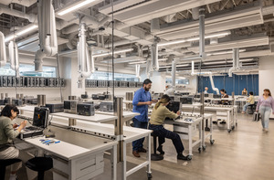 Students working in a bright, open laboratory environment.