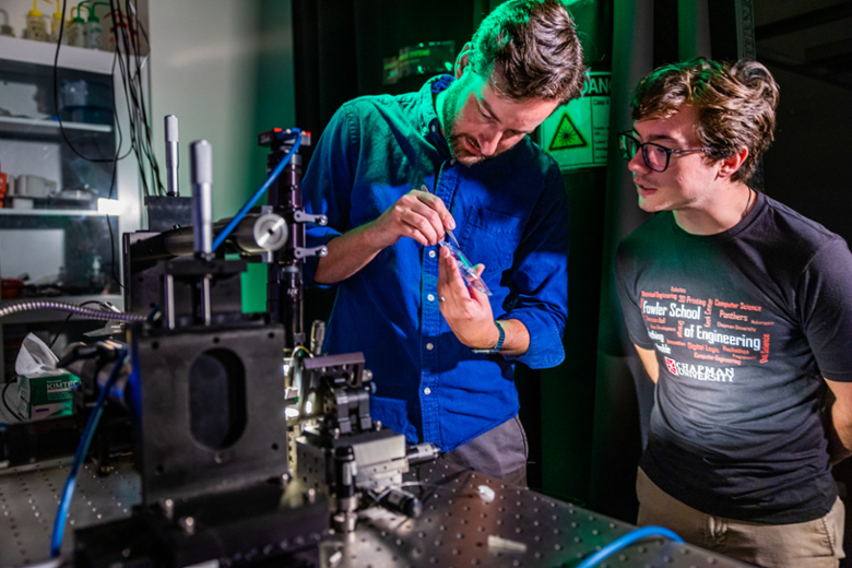 Professor and student in the optics lab