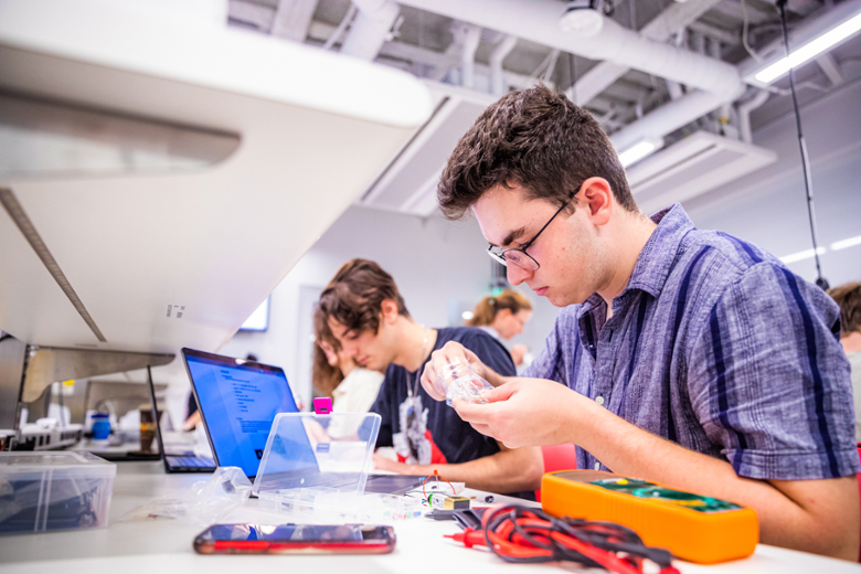 Students work with equipment in an engineering class.