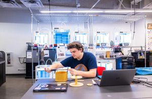 A student works in an engineering classroom.