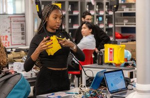 Students work in a lab, designing electronics.