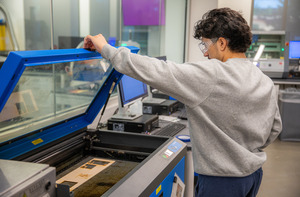 A student works with equipment in a lab in Swenson Hall.