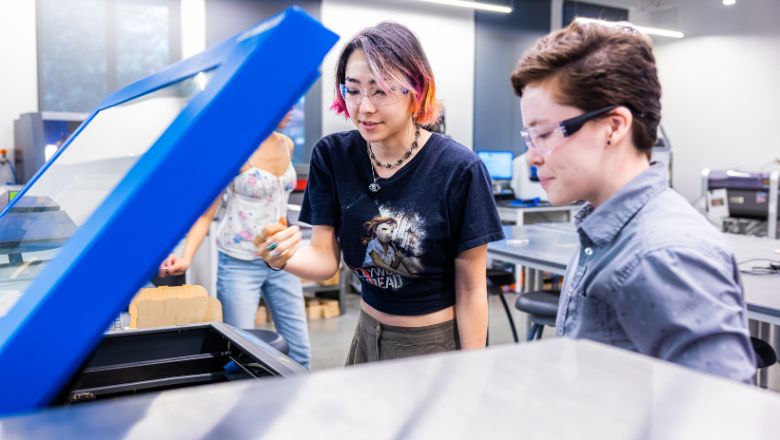 A student and instructor working inside our Makerspace.