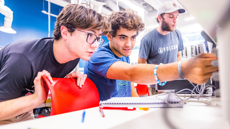 Students work on a project in a brightly lit lab.